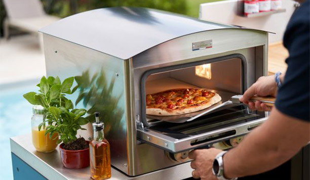 Homme sortant une pizza cuite dans le four à pizza électrique Signature 450 Le Marquier