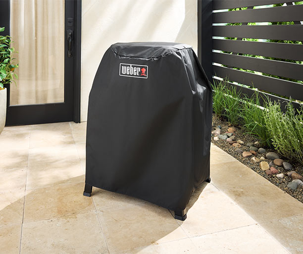 Housse premium Weber installé sur le barbecue électrique Lumin sur stand